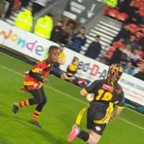 2 young people playing rugby
