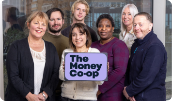 Staff smiling with the Money Coop logo