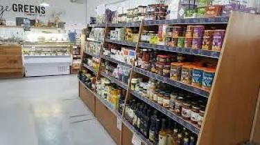 Shopping aisle with cans and dried food, as well as non-food retail products